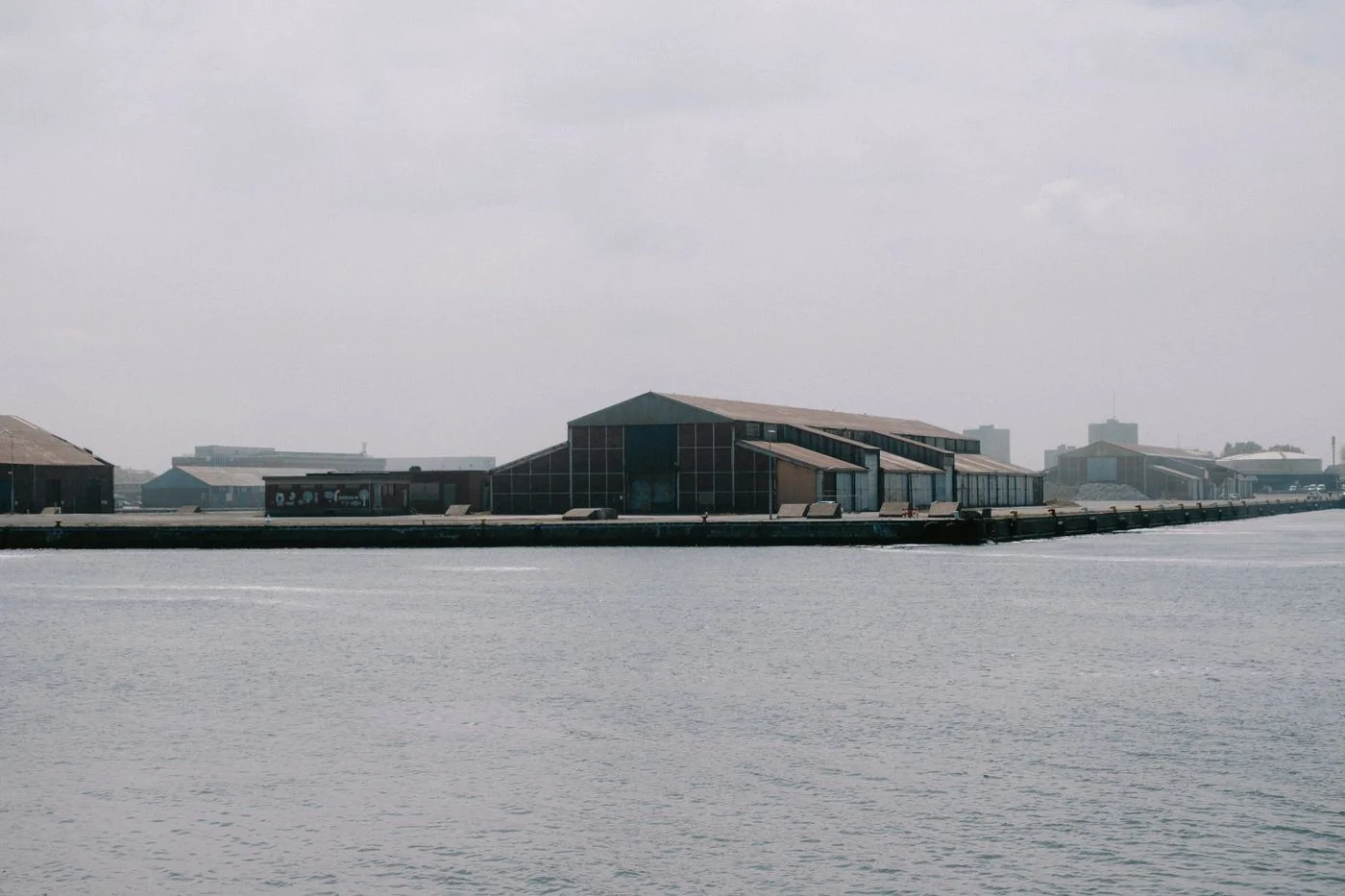 Industrial warehouses at a port quay, seen from the water